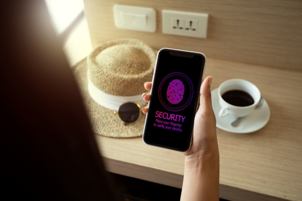 woman-holiday-using-smartphone-sign-password-by-fingertip-mobile-security-concept